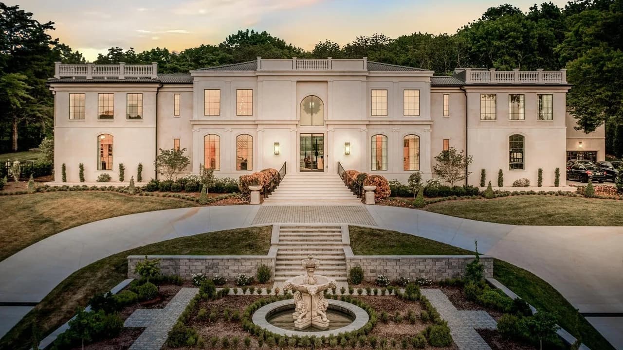 The Harpeth Hills Estate at sunset, warm light across the fountain arrival